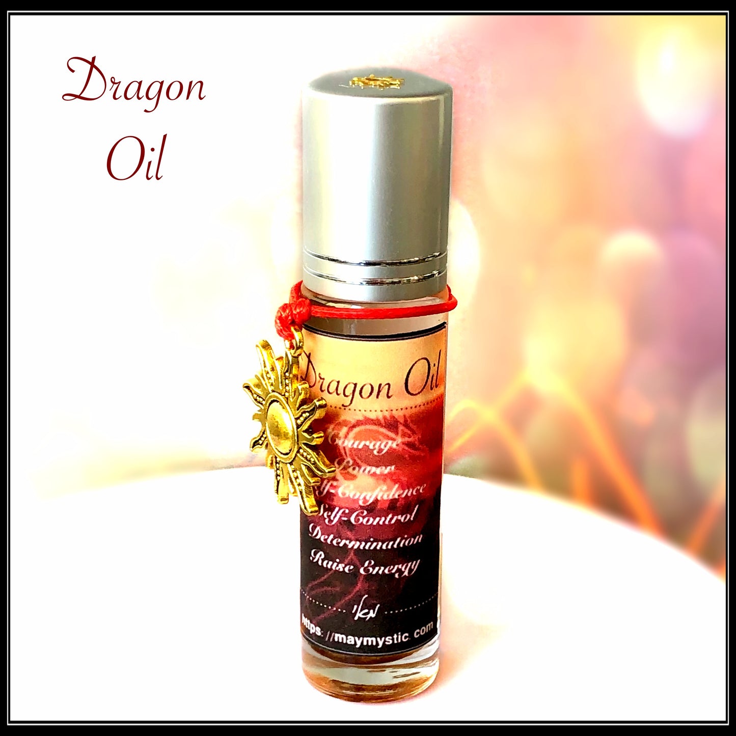 שמן Dragon’s Oil בבקבוק גלילי ענבר עם מכסה כסוף ועיטור מוזהב